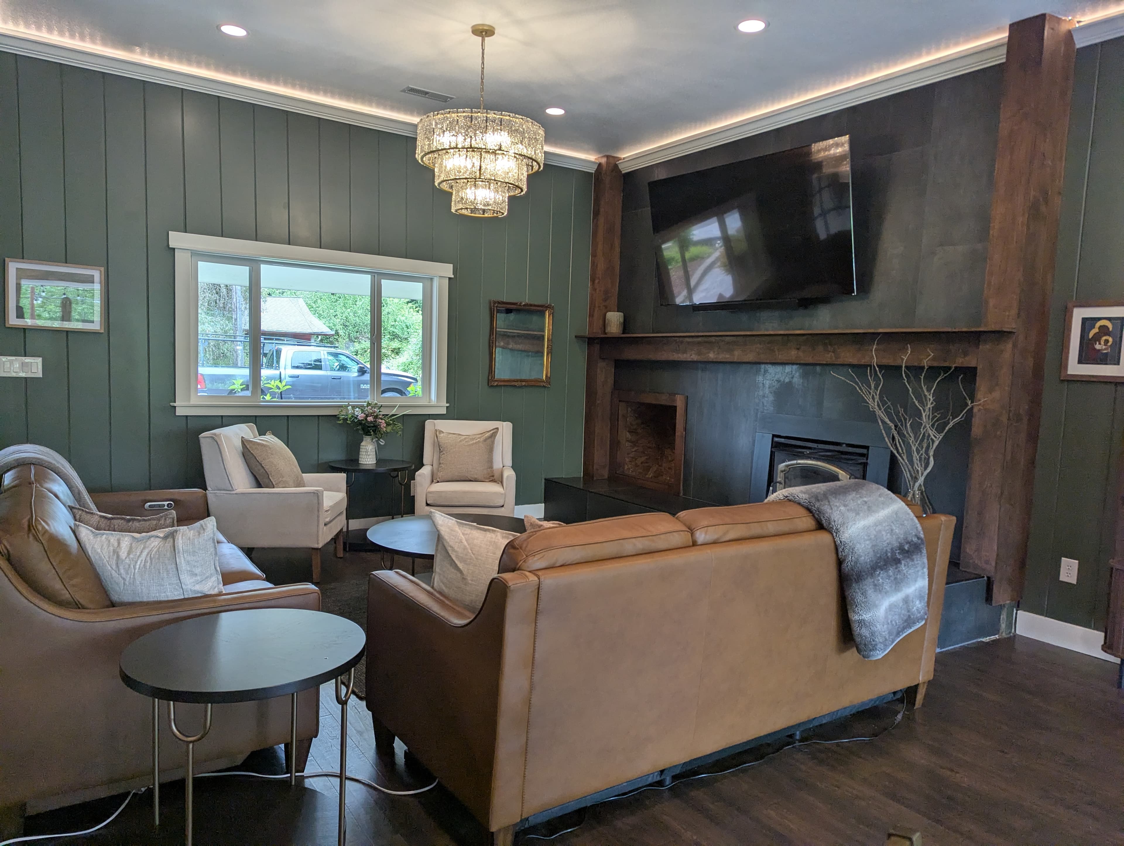 Living room remodel with green shiplap walls and custom fireplace surround