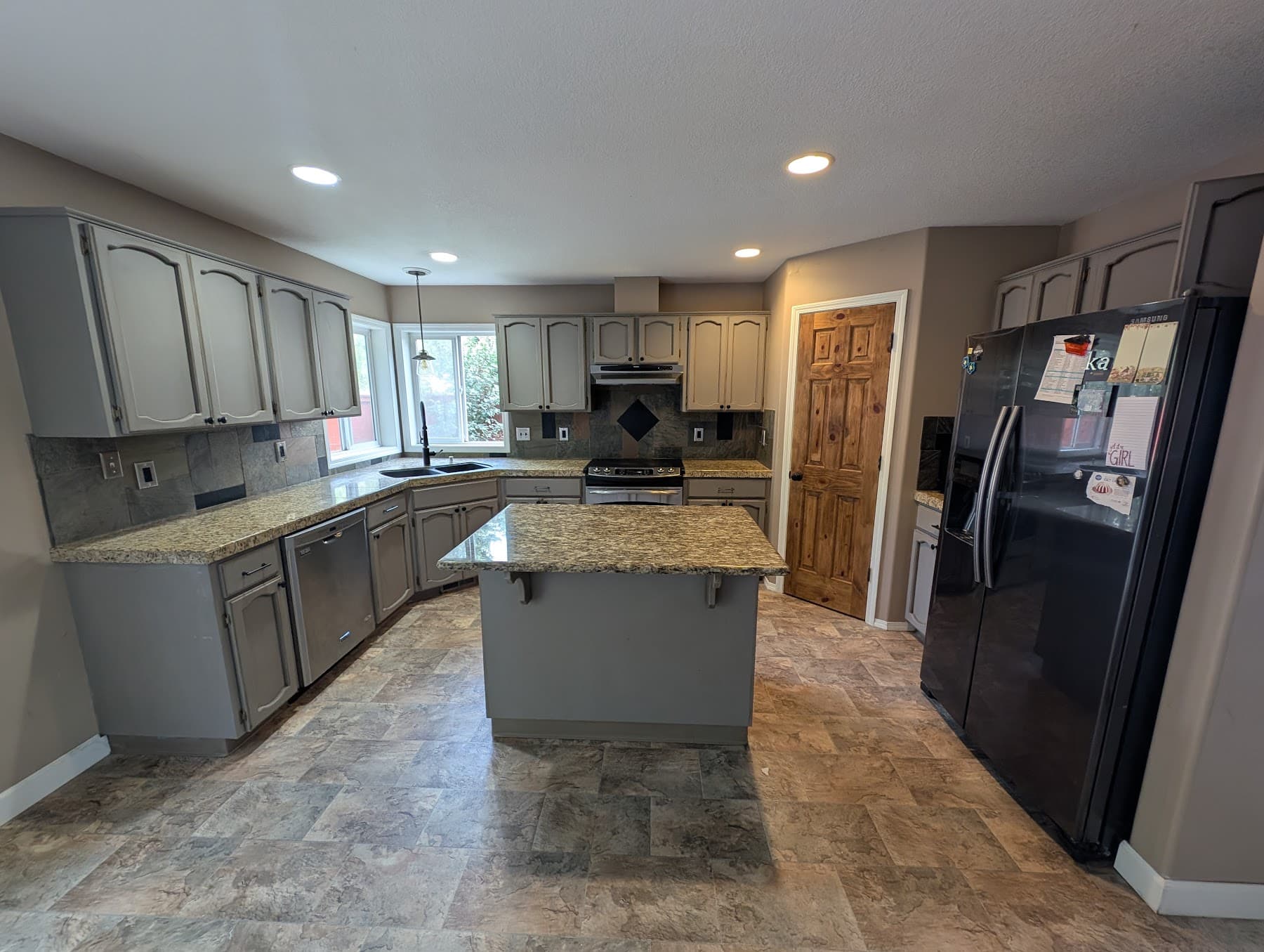 Dated kitchen with painted cabinets and granite counters before remodel